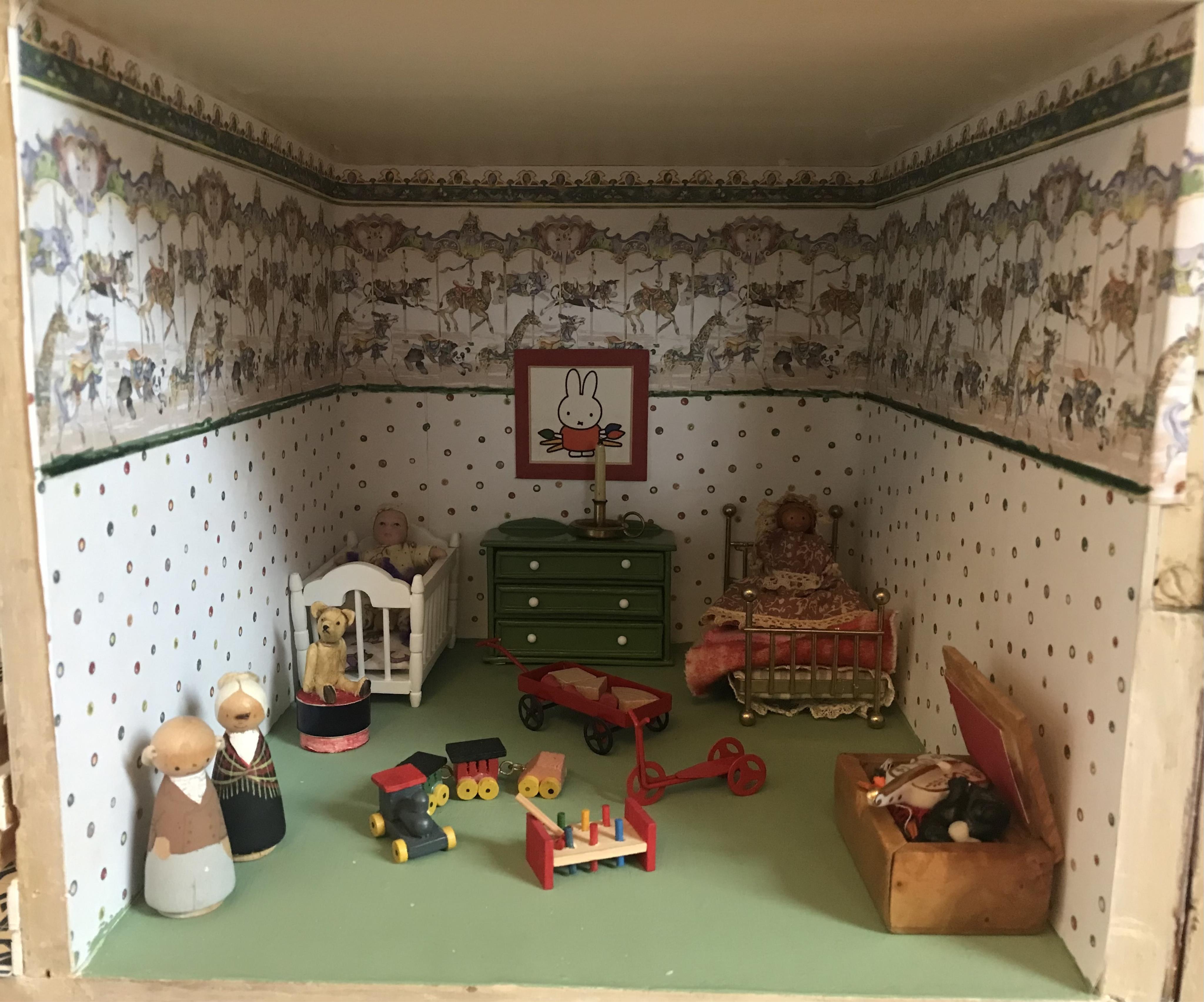 A late 19th century doll's house, with a single front opening panel, incorporating eight internal rooms, flat roof with parapet, dimensions 81.5cm high, 79cm wide, 30cm deep, together with modern manufactured furniture a